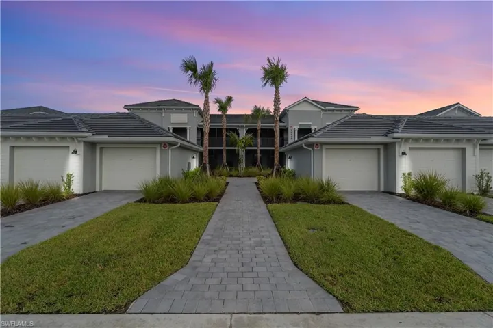 Paver driveways and walkways, manicured landscaping, and attached garages