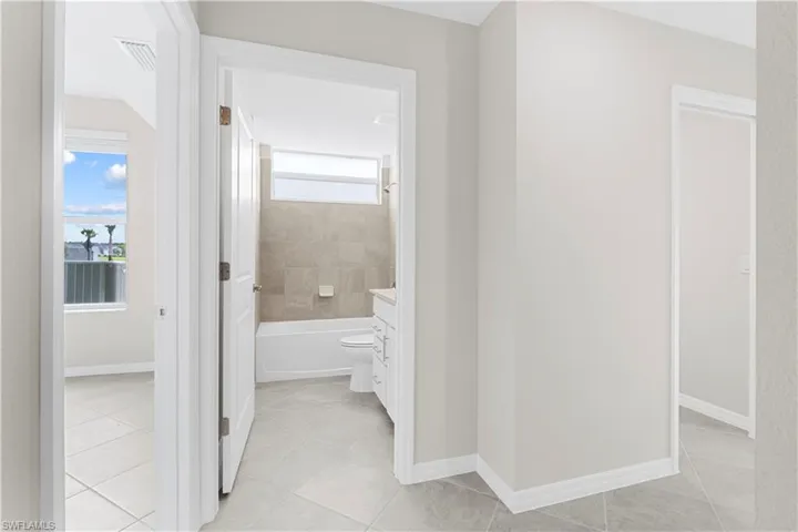 Light gray wall paint, white trim, and light-toned tile flooring