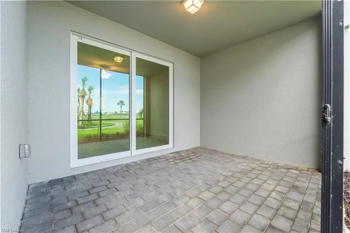 Covered outdoor patio featuring paver flooring