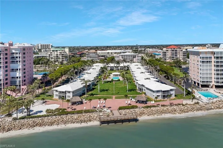Drone / aerial view with a beach view, a view of city, and a water view