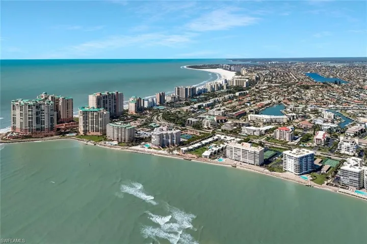Birds eye view of property featuring a view of city and a water view