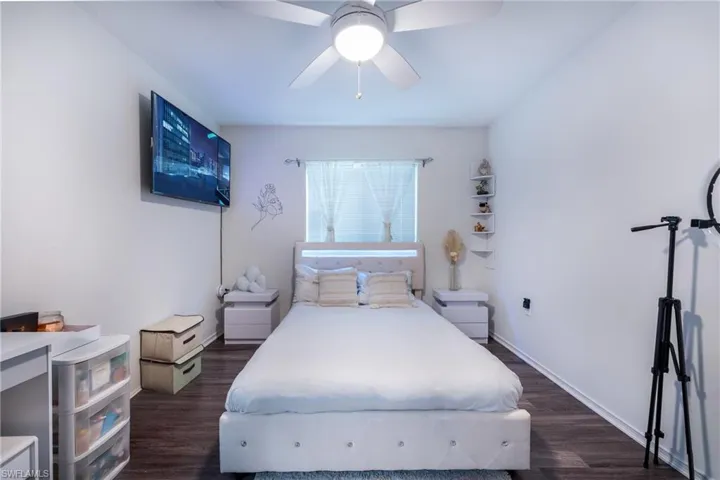 Bedroom featuring ceiling fan and dark wood-type flooring