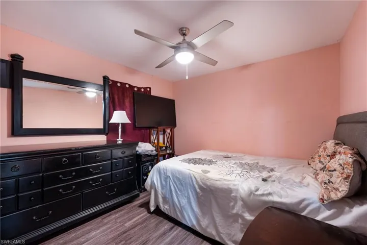Bedroom with ceiling fan and dark hardwood / wood-style flooring