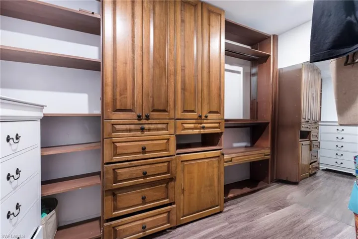 Spacious closet with light hardwood / wood-style floors