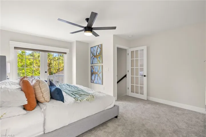 Master Bedroom featuring french doors, carpet floors, a ceiling fan, and balcony