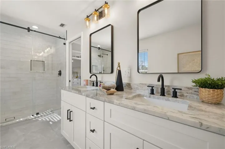 Master bathroom featuring double vanity and a large walk-in shower