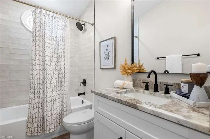 Bathroom with vanity and shower / tub combo
