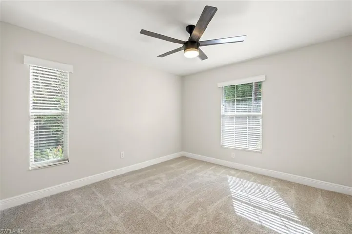 Bedroom 1 with carpet and a ceiling fan