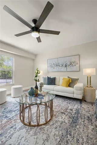 Den/ Bonus room featuring ceiling fan and baseboards