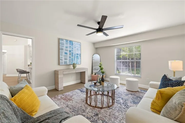 Den/Bonus room featuring wood finished floors and ceiling fan