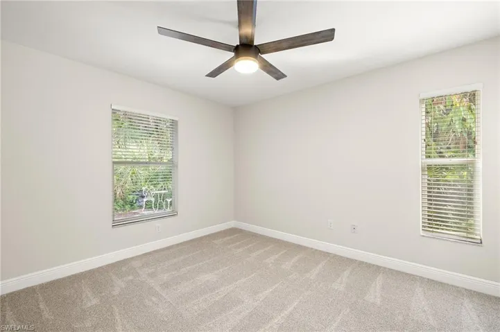 Bedroom 2 with carpet and a ceiling fan