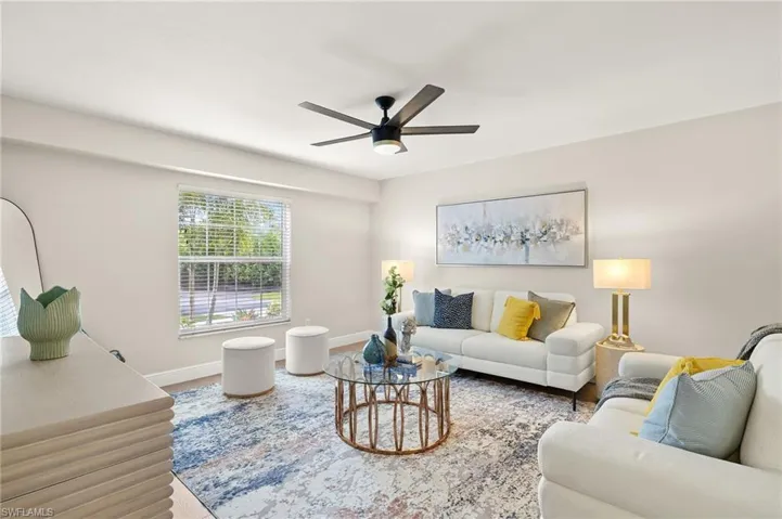 Den/Bonus room with a ceiling fan and wood finished floors