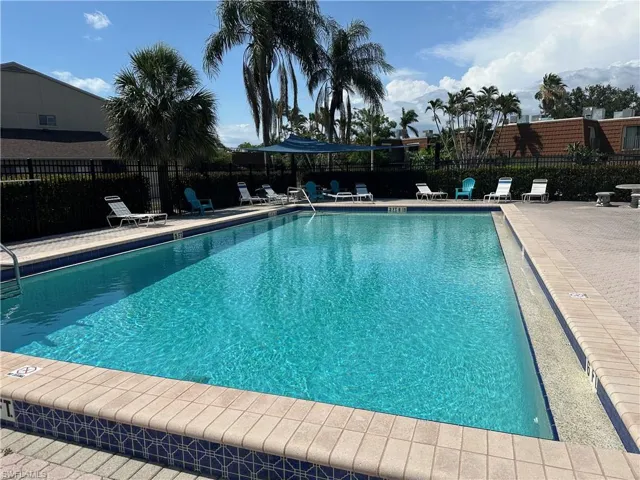 Community pool with a patio