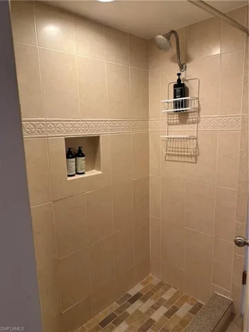 Full bath featuring a tile shower