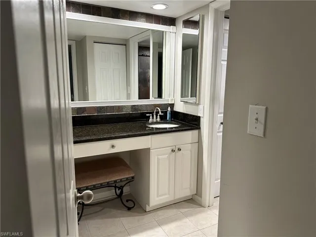 Bathroom featuring tile patterned floors and vanity