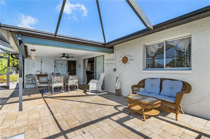 Pavered Patio next to pool with pocket sliders from the home.
