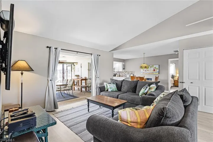 Family Room with views of the pool, dining area, and kitchen for an open plan.  There is an "owner's closet" in the far right of the photo.