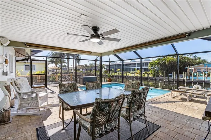 Covered area next to the pool with pocket sliders from the family room and kitchen for entertaining ease.