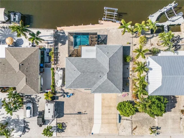 Aerial of lot, pool, almost 80' of composite dock, and lift.