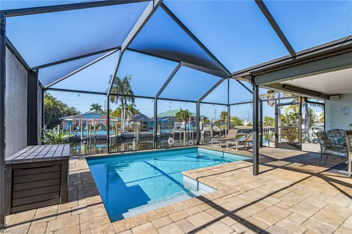 Screened pool with pavered deck built in 2019, with a covered area to relax.