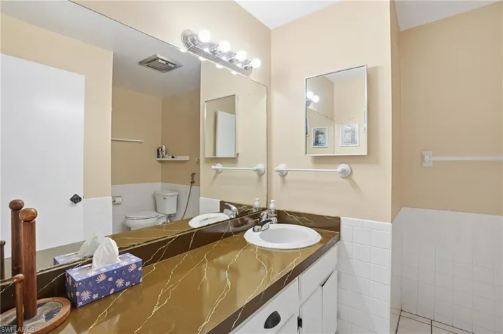 Bathroom featuring vanity and tile walls