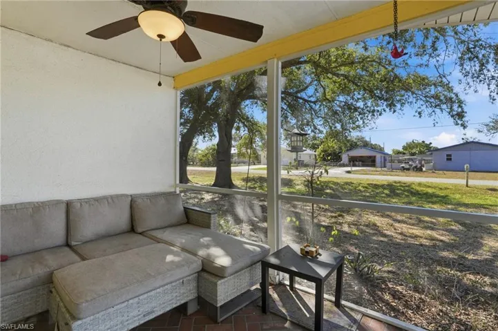 Sunroom with a ceiling fan and outdoor lounge area