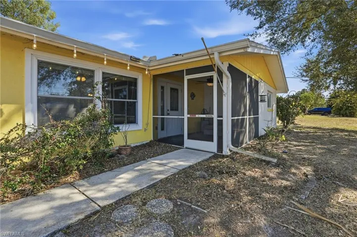 Property entrance featuring a sunroom