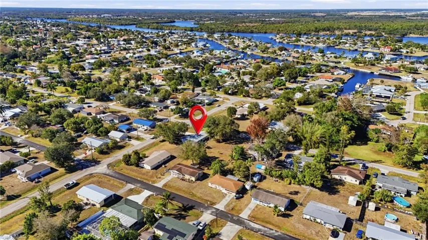 View of property location with nearby suburban area and a nearby body of water