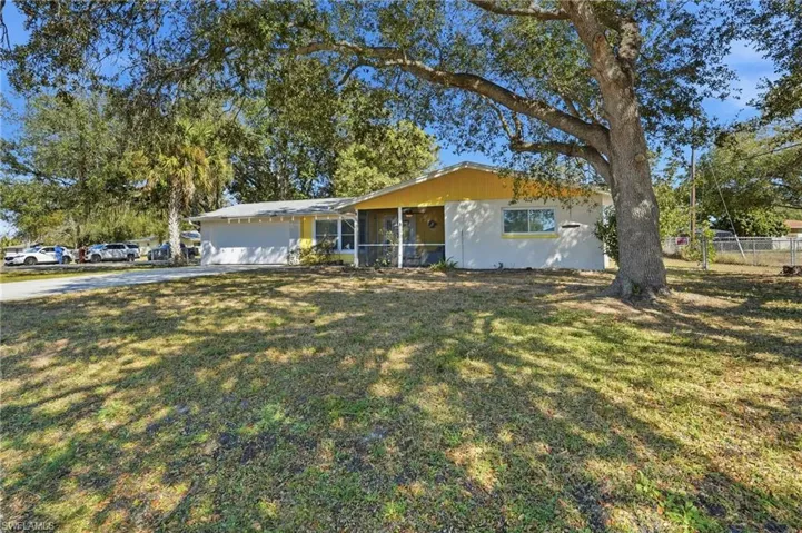 Single story home with concrete driveway and a garage