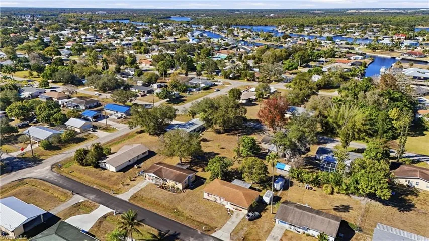Aerial overview of property's location with nearby suburban area and a large body of water
