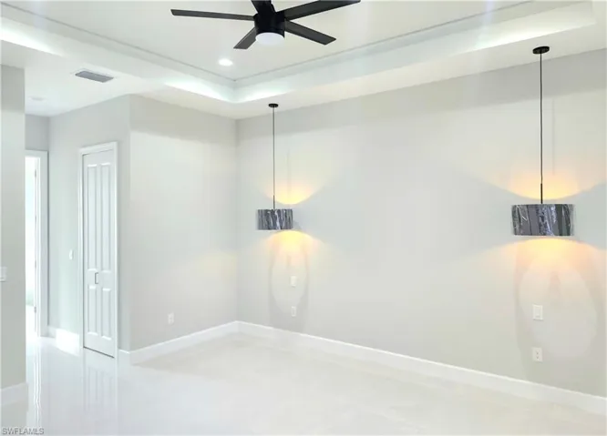 Unfurnished room with a tray ceiling, recessed lighting, and a ceiling fan