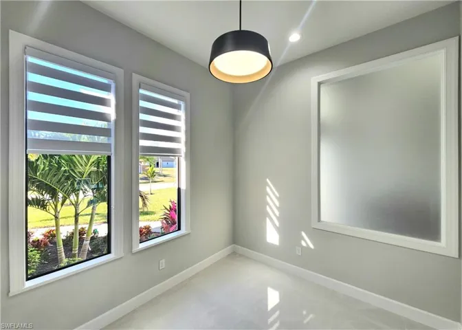 Empty room with baseboards and recessed lighting