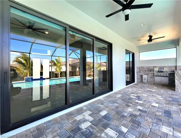 View of patio / terrace featuring a ceiling fan, area for grilling, and an outdoor pool