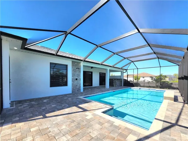 Outdoor pool with a sunroom, a lanai, and a patio