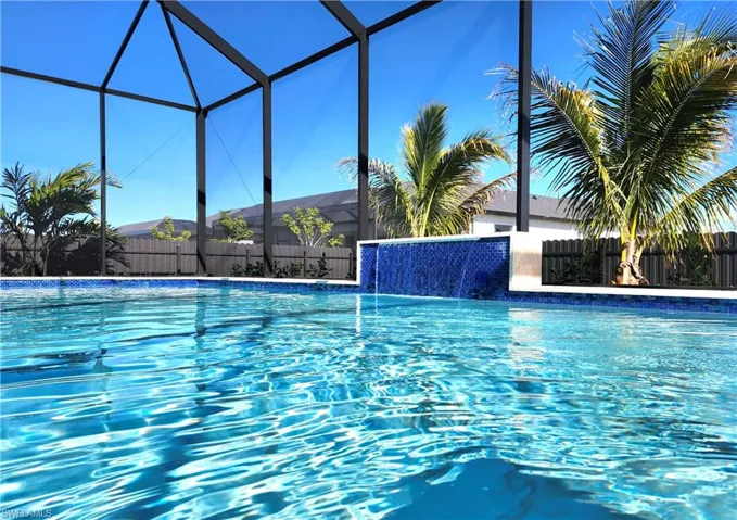 View of pool with a sunroom and glass enclosure