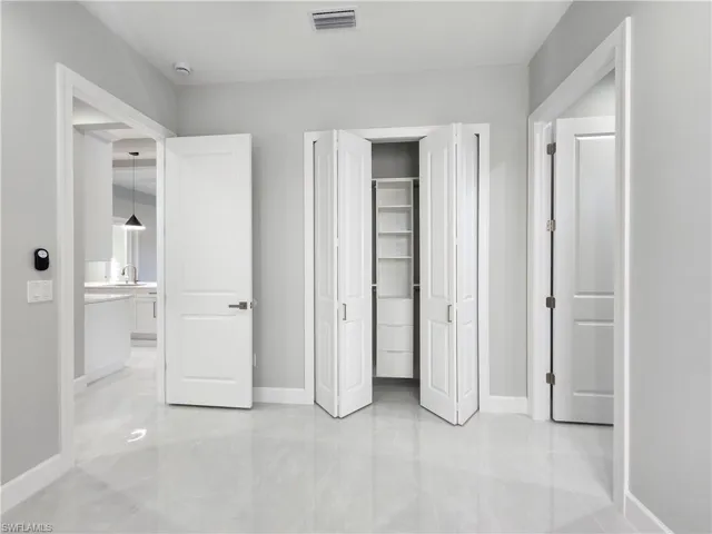 Unfurnished bedroom with a closet and baseboards