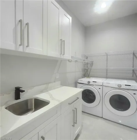 Laundry room with washing machine and clothes dryer and cabinet space