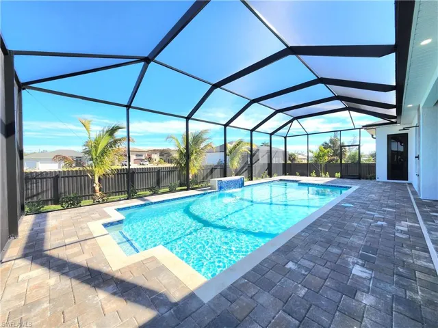 View of pool featuring a patio, a sunroom, a lanai, and a fenced backyard