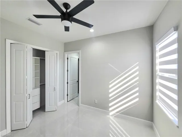 Unfurnished bedroom with ceiling fan, a closet, and recessed lighting