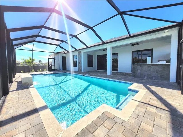View of pool with a sunroom, a lanai, and a patio area