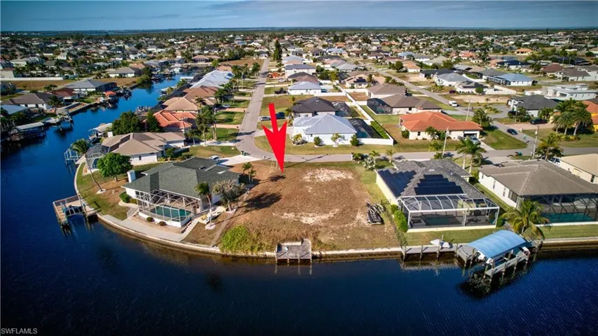 Aerial overview of property's location featuring a large body of water and nearby suburban area