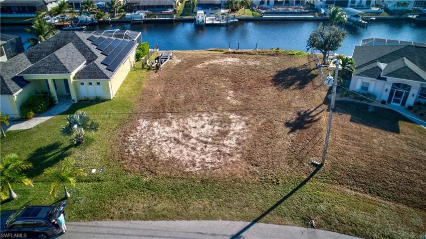 Aerial perspective of suburban area with a nearby body of water