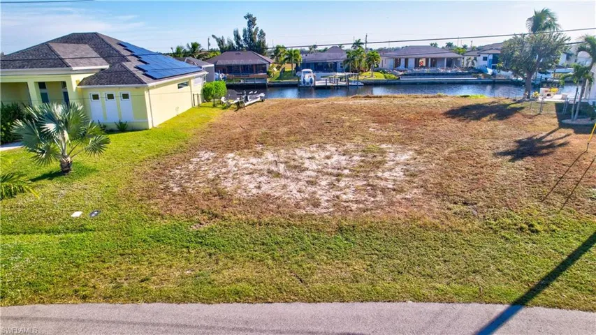 View of yard featuring a residential view and a water view