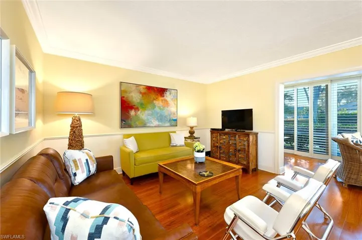 Living room featuring crown molding and wood-type flooring