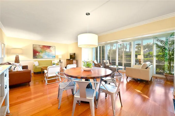 Dining room featuring ornamental molding and wood-type flooring