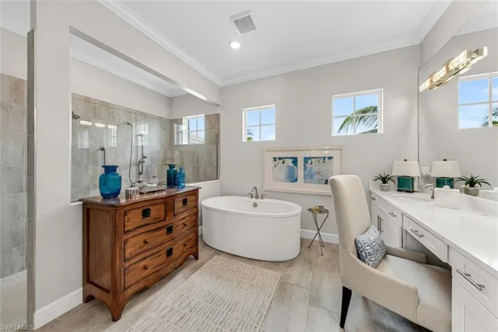 Spa style soaker tub, double sink vanity with quartz counters, upgraded lighting, and additioanl heating unit for chilly days.