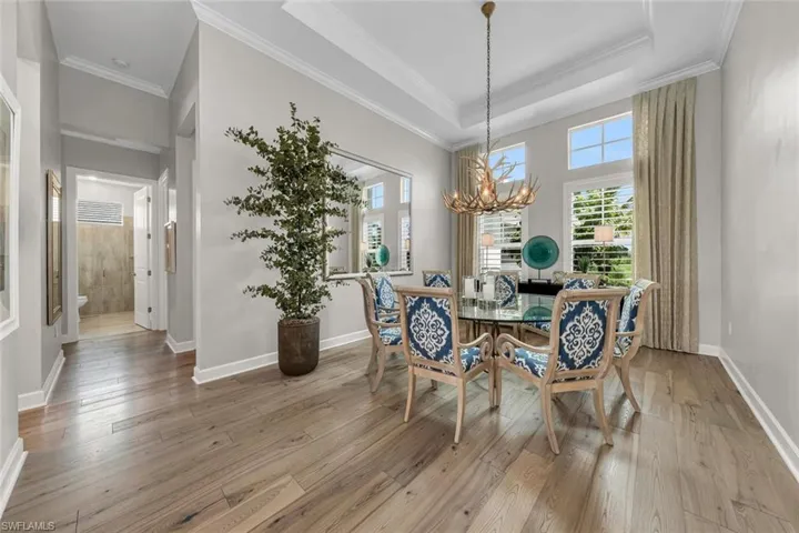 Plantation shutters, dignified antler chanderlier and tray ceiling adds a classic touch.