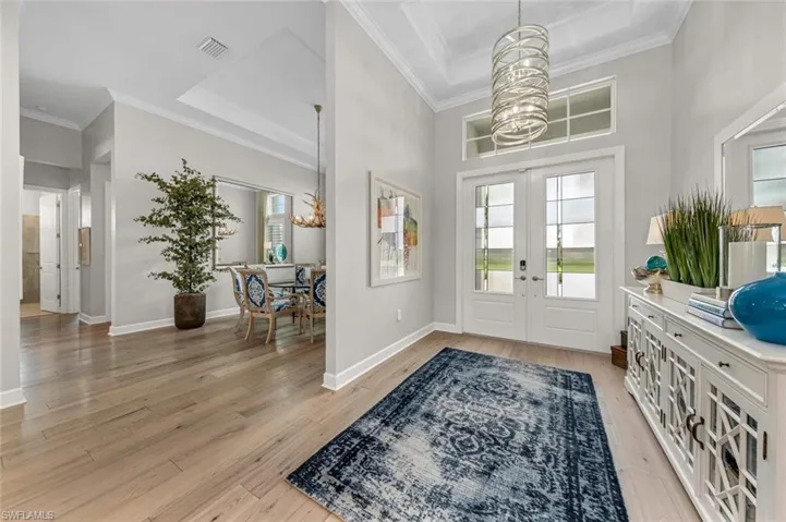 Spacious foyer with stunning glass chandelier.