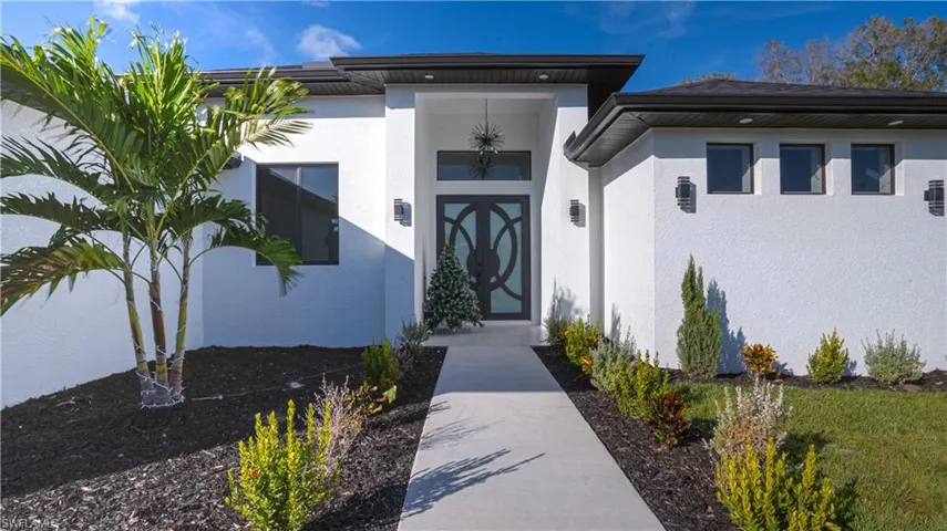 Entrance to property featuring stucco siding