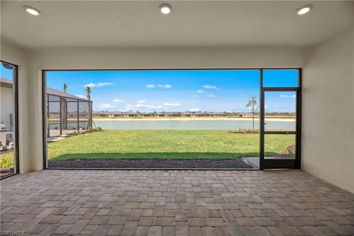 Unfurnished sunroom featuring a water view